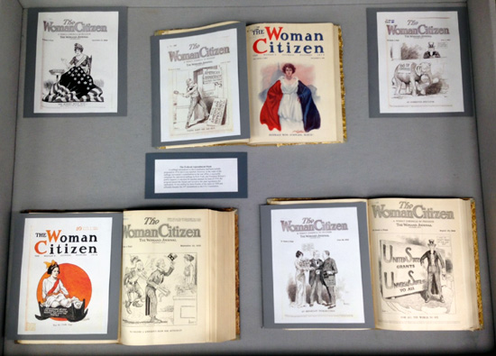 center display case, with magazine covers related to the passage of the 19th amendment