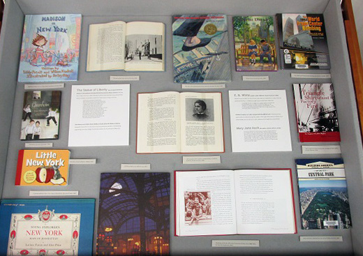 The center display case features children's books focusing on New York City.