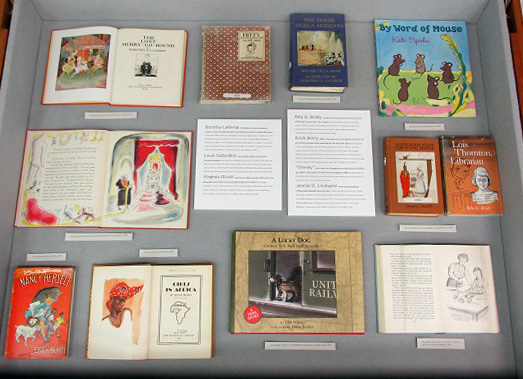 The left display case includes books by Albany authors or illustrators.