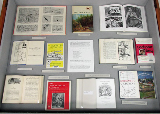 The right display case includes books about Western New York and the Erie Canal.