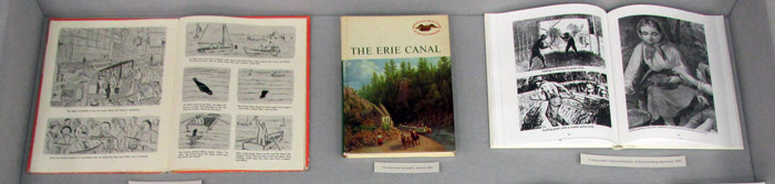Part of dispaly case 3, showing the books )ley the Sea Monster, The Erie Canal, and A Young People's History of Rochester.