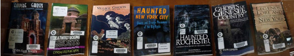 Display case showing books about ghosts in various parts of New York State.