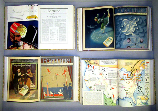 right display case, showing bound copies of Fortune, opened to various covers and illustrations