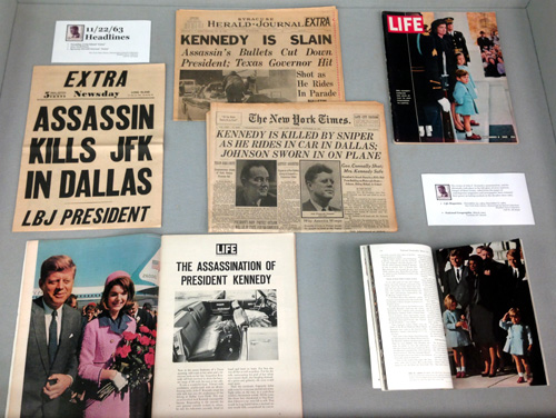 Left display case, showing newspapers and magazine coverage of Kennedy's assassination and funeral.