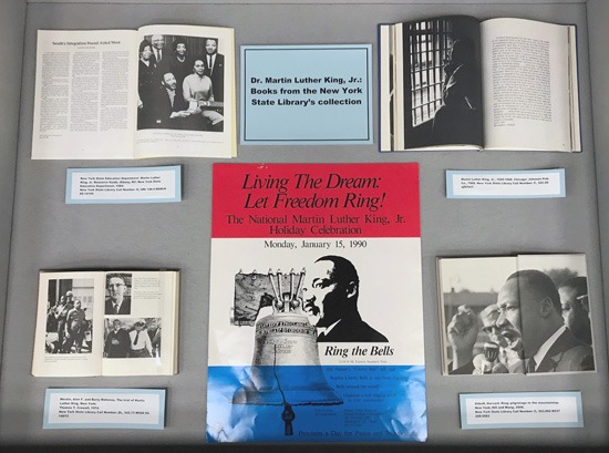 middle display case, showing more books with photos of King, and a poster from a 1990 event