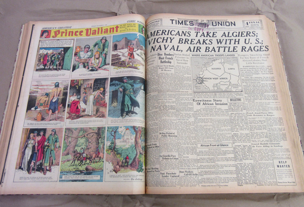 Bound issues of the Times Union from 1942, with comics on the left side and WWII headlines on the right
