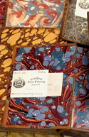 Books opened to show marbled andpapers and NYSL bookplates