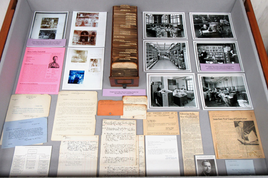 NYSL Bicentennial Farewell, left case, with photos, documents, and a drawer of singed catalog cards from the 1911 fire