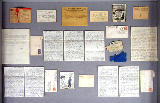 right display case, containing letters and other items from the A. Francis McCaw collection.