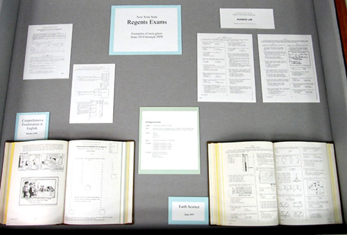 Center display cases, showing Regents materials from 1970s.